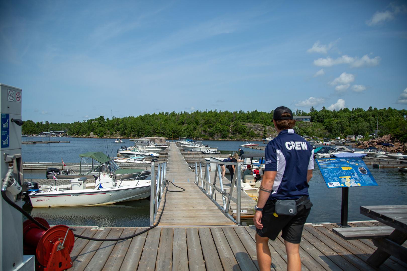 Dock staff walking to the dock to assist boaters
